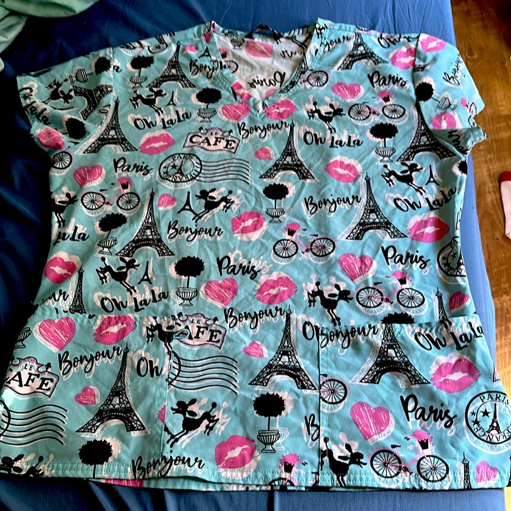 This is a Samantha Mara srub top. It’s light blue with pink and black
